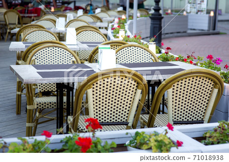 terrace summer cafe with tables and chairs for people, an empty institution for recreation, nobody. terrace summer cafe with tables and chairs for people, an empty institution for recreation, nobody. 71018938