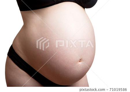 big round belly of a pregnant woman no face in black underwear close up isolated on white background. 71019586