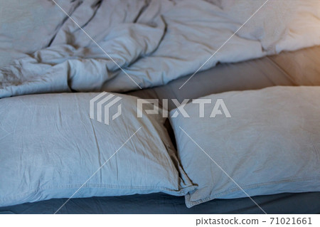 Blue bed sheets and pillows after night's sleep. Blue bed sheets and pillows after night's sleep. 71021661