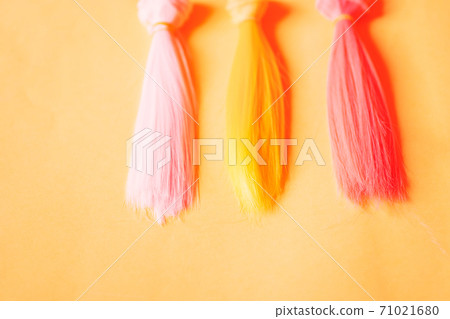 Colorful dolls hair on pink background Colorful dolls hair on pink background 71021680