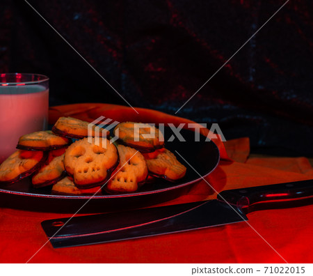 Halloween skull cookies with milk and butcher knife Halloween skull cookies with milk and butcher knife 71022015