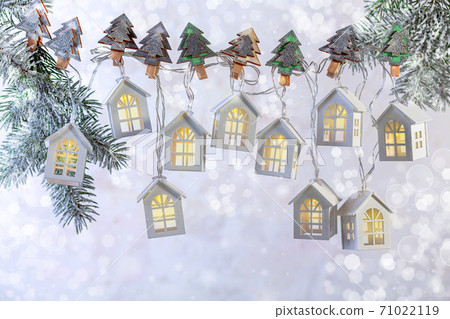 Beautiful Christmas garland of lights in the form of white houses. Beautiful Christmas garland of lights in the form of white houses. 71022119