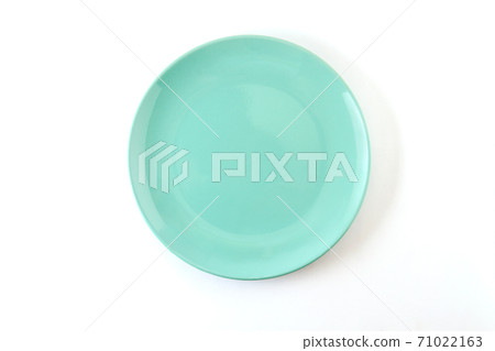 A plate of pastel turquoise color on a white background. 71022163