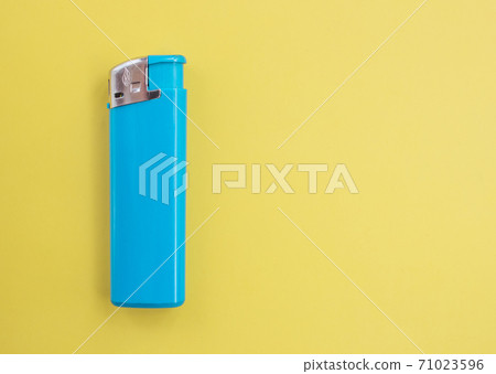 A turquoise lighter on a bright colored background with copy space. Smoking concept 71023596