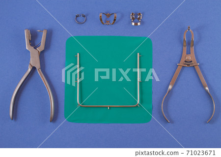 Tools for installing the cofferdam lying on a blue background. Tools for installing the cofferdam lying on a blue background. 71023671