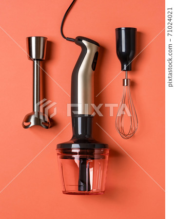 Immersion hand blender, whisk for whipping and chopper cup on a coral background. 71024021