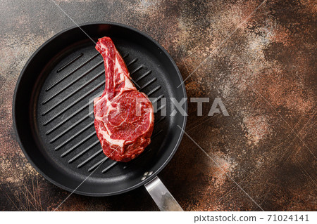 Spencer steak on the grill pan skillet or Scotch Fillet raw top view. ove rustic metal dark background table. with space for text 71024141