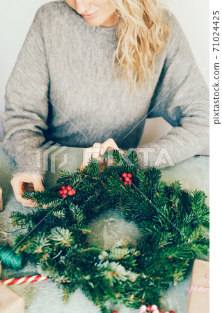 woman making christmas fir wreath woman making christmas fir wreath 71024425