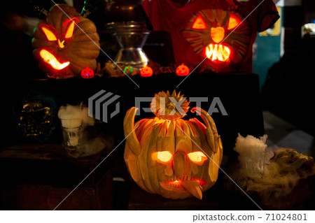 Halloween pumpkins head lantern with scary jack faces in dark 71024801