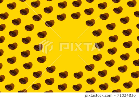 Creative bright collage of real macro photos of selected coffee beans on a yellow background with a hard shadow in the shape of a heart with a place for inscription. 71024830