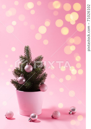 Small decorative Christmas tree on a pink background. Small decorative Christmas tree on a pink background. 71026102