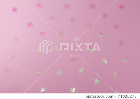 A gentle transparent white snowflake on a light pink background. A gentle transparent white snowflake on a light pink background. 71026275