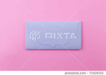Blue bright envelope on a pastel pink background. 71026333