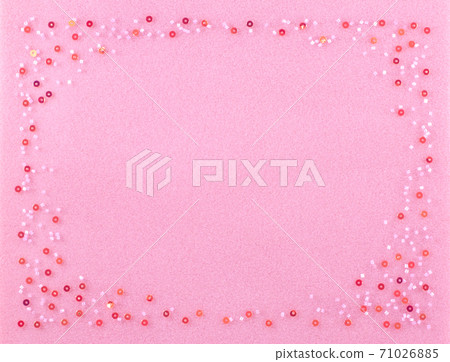 Set of beads on a pink background. 71026885