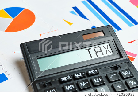 Tax concept on calculator and chart sheets Tax concept on calculator and chart sheets 71026955