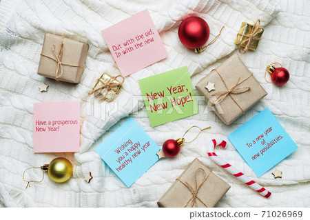 New year and christmas concept with wishes on leaflets for gifts 71026969