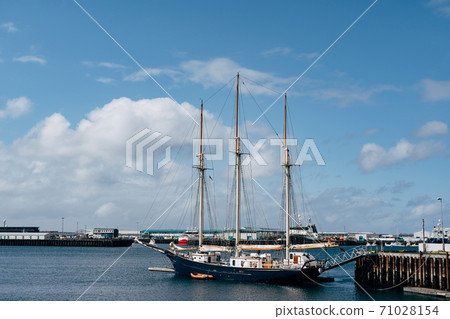 Sailing wooden ship with three masts moored in the port of Reykjavik, in the capital of Iceland. Sailing wooden ship with three masts moored in the port of Reykjavik, in the capital of Iceland. 71028154