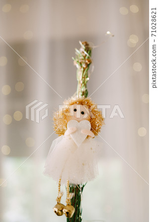 Christmas tree toy on top of a tree - a little girl with a heart in her hands. Christmas tree toy on top of a tree - a little girl with a heart in her hands. 71028621