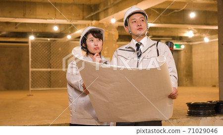 Business woman checking progress at construction site 71029046