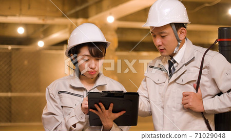 Business woman checking progress at construction site Business woman checking progress at construction site 71029048