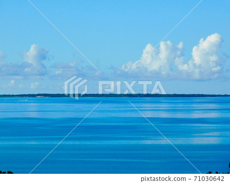 Taketomi Island over the striped emerald blue sea 71030642