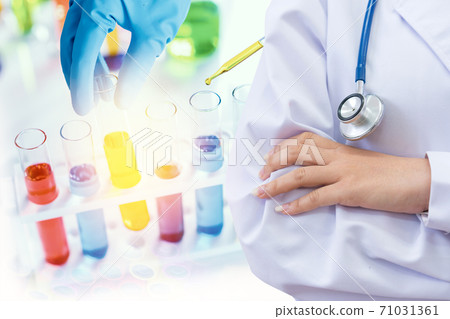 Doctor and microbiologist with vacuum tubes for samples with COVID 19 infection  71031361