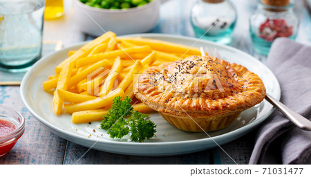 Meat pie with french fries on a plate. Wooden background. Close up. 71031477