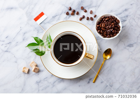Cup of coffee with Indonesian flag on marble table. Top view. 71032036