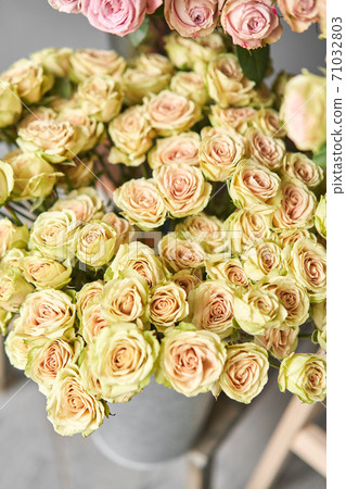 Big luxury bright bouquet peony rose on wooden table. Garden spray roses of lilac, pink and green color . bouquet in metal vase 71032803