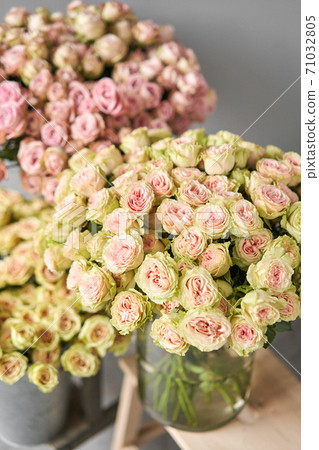 Big luxury bright bouquet peony rose on wooden table. Garden spray roses of lilac, pink and green color . bouquet in metal vase Big luxury bright bouquet peony rose on wooden table. Garden spray roses of lilac, pink and green color . bouquet in metal vase 71032805