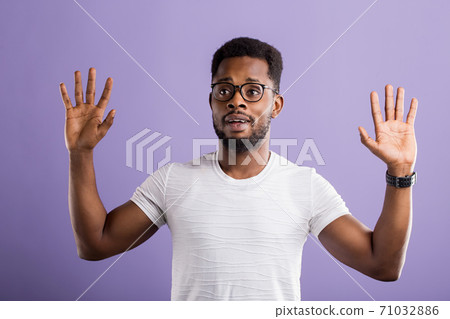 Dark skinned man isolated over purple background Dark skinned man isolated over purple background 71032886