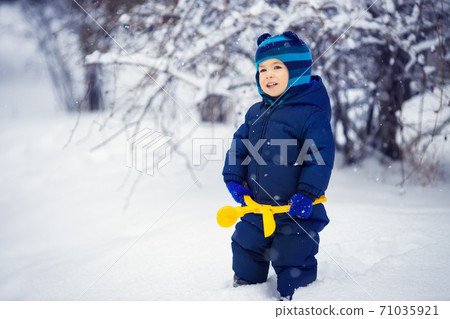 little boy with toy for making snowballs little boy with toy for making snowballs 71035921