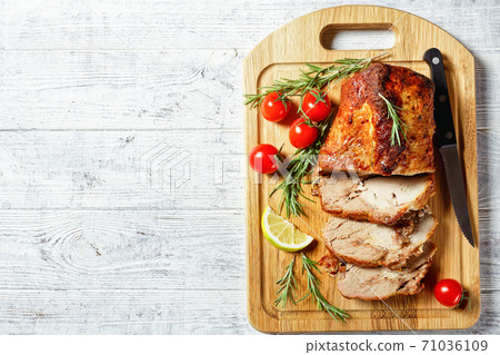 Sliced roasted pork on a white wooden background Sliced roasted pork on a white wooden background 71036109
