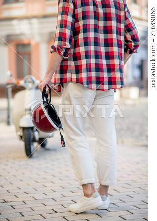 Man holding a stylish red retro helmet 71039066