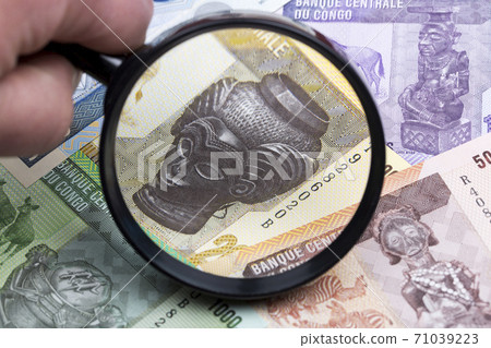 Congolese franc in a magnifying glass 71039223