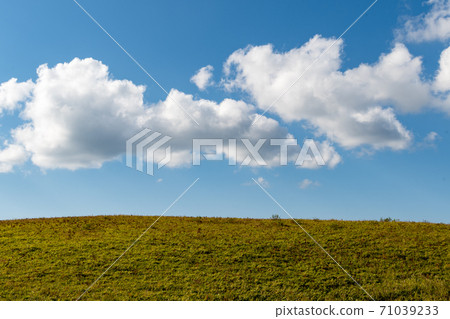 藍天和白雲蔓延到草地之外似乎可以到達的雲 71039233