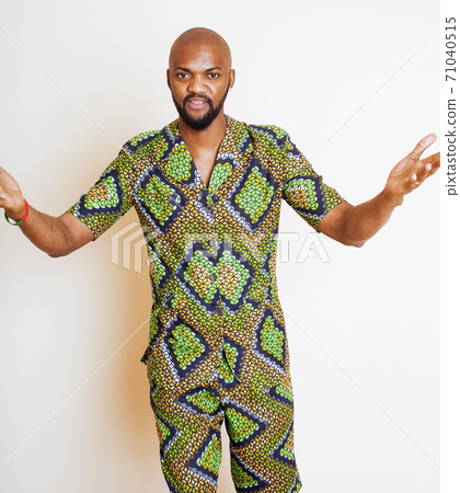 portrait of young handsome african man wearing bright green national costume smiling gesturing, entertainment stuff portrait of young handsome african man wearing bright green national costume smiling gesturing, entertainment stuff 71040515