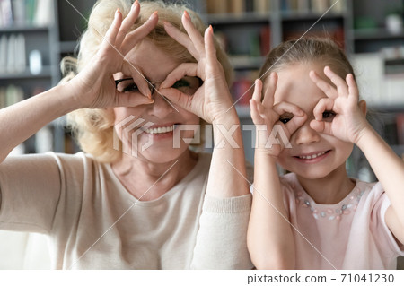 Mature grandmother having fun with cute little granddaughter. Mature grandmother having fun with cute little granddaughter. 71041230