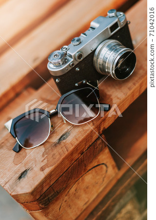 Vintage camera on a wooden surface close-up 71042016