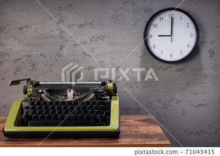 old typewriter at wooden desk table near wall 71043415