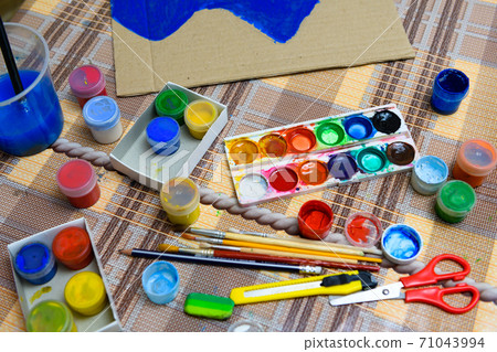 watercolor paints and paper closeup for drawing, artistic creation at home, workspace for make creative artwork 71043994