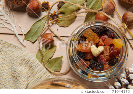 christmas decoration in rustic style and holiday background, still life on wooden backdrop, bread, nuts and other christmas decoration in rustic style and holiday background, still life on wooden backdrop, bread, nuts and other 71044173
