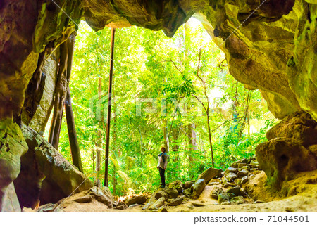 Woman in exit of dark cave Woman in exit of dark cave 71044501