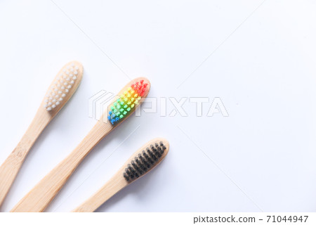 colorful toothbrushes on white background with copy space  71044947