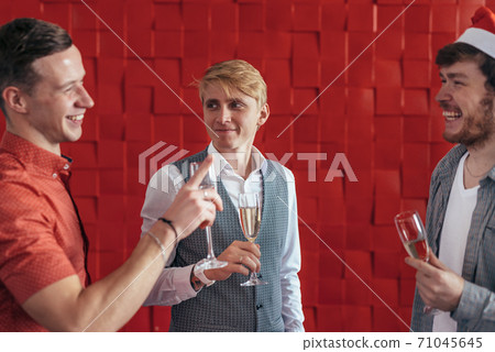 Three young men celebrate Christmas or New Year Three young men celebrate Christmas or New Year 71045645