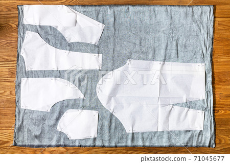 top view of paper sewing pattern layouts on fabric 71045677