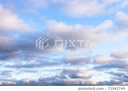 low fluffy gray clouds in blue sky in twilight low fluffy gray clouds in blue sky in twilight 71045749