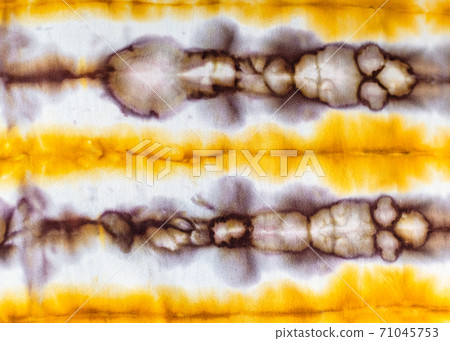 abstract spotted yellow and brown pattern in batik 71045753