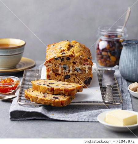 Fruit cake Bara Brith. Welsh traditional dessert. Grey background. Close up. Fruit cake Bara Brith. Welsh traditional dessert. Grey background. Close up. 71045972