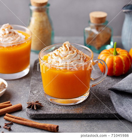 Pumpkin spice latte with whipped cream in glass cups. Grey background. Close up. 71045986